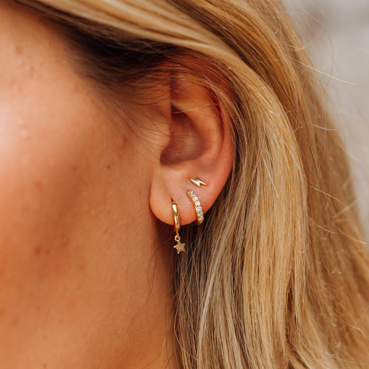 Tres aros simples con estrella y rayo en dorado