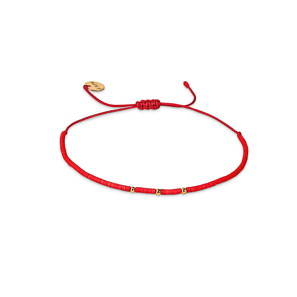 Pulsera roja con mostacillas bañadas en oro